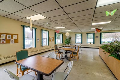 Bright common area with tables and windows
