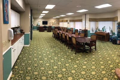Brightly lit common area with tables and chairs