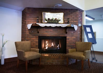 Cozy sitting area by a fireplace in the facility