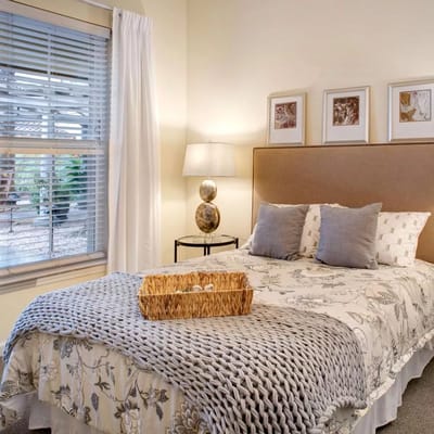 Well-decorated private room with a bed and natural light