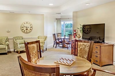 A cozy common area with seating and a clock