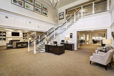 Bright lobby with seating and decorative staircase