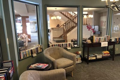 Cozy reading corner with bookshelves and comfortable chairs