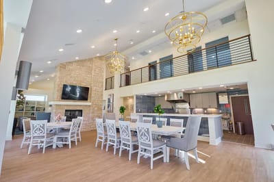 Bright common area with dining tables and modern decor