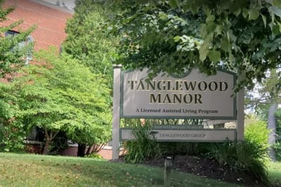 Outdoor view of Tanglewood Manor sign and landscaping