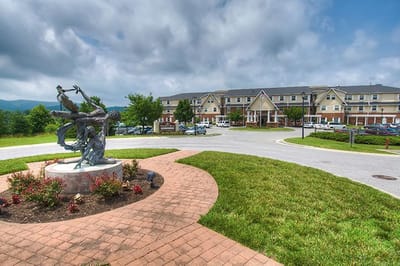 Exterior view of the Pheasant Ridge facility with landscaping and sculpture