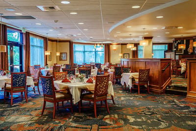 Elegant dining room setup with white tablecloths and decor