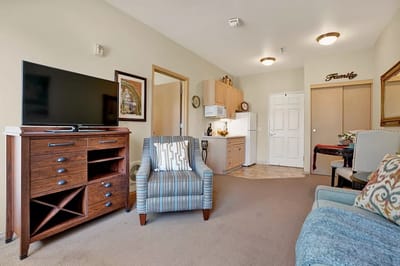 A cozy resident room with TV and kitchen area