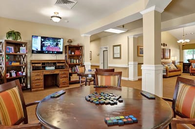 Common area with residents playing games and watching TV