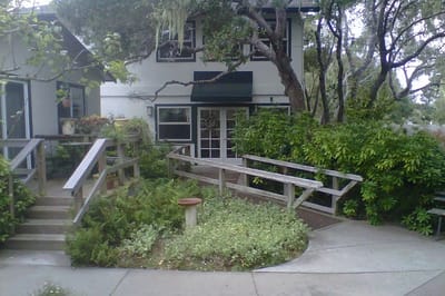 Exterior view of the facility with landscaped pathways