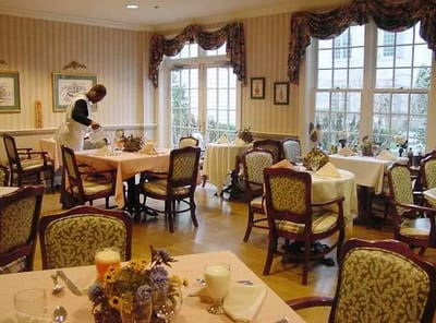 Dining room with staff member preparing tables