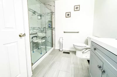 Interior bathroom with grab bars and shower chair