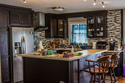 Modern kitchen with black cabinets and bar stools
