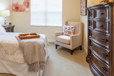 Cozy resident room with a bed and chair