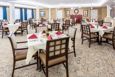 Dining room set up for a meal with decorated tables