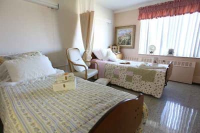 Cozy resident bedroom with two beds and seating area