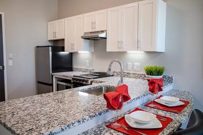Modern kitchen with granite countertops and dining setup