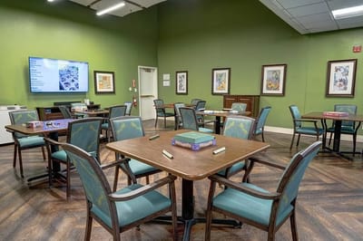 Interior view of a recreational activity room with tables and chairs