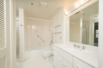 The Peninsula Regent, independent living in San Mateo, CA — Bright, clean bathroom with modern fixtures and amenities