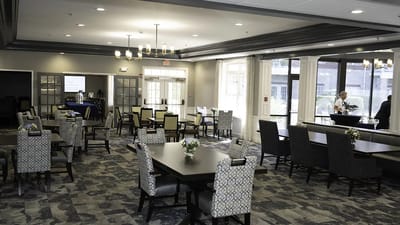 Dining area with tables and chairs in a bright setting