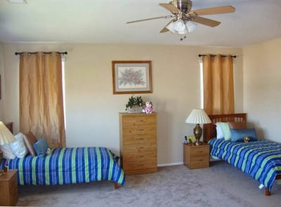 A cozy resident room with two beds and decorations
