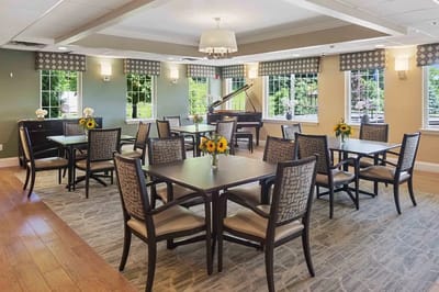 Bright common area with tables and flowers