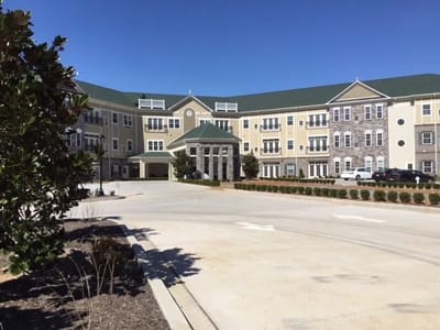 Exterior view of The Villages at the River Club building