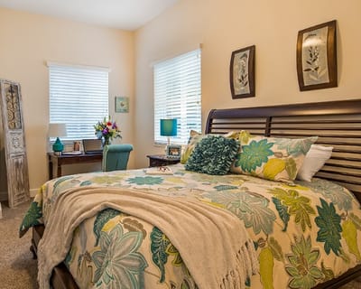 Cozy resident bedroom with floral bedding and decor