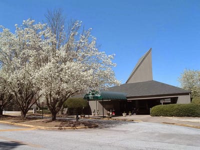 Exterior view of Woodland Ridge Assisted Living with flowering trees