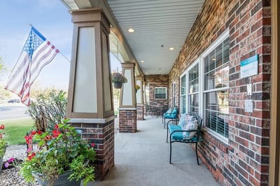 Front porch with seating and American flag