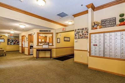 Interior lobby with mailboxes and community photos