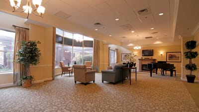 Bright common area with seating and piano