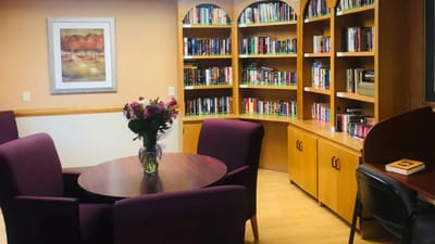 Cozy reading nook with bookshelves and flowers