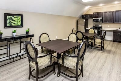 Well-furnished common area with dining tables