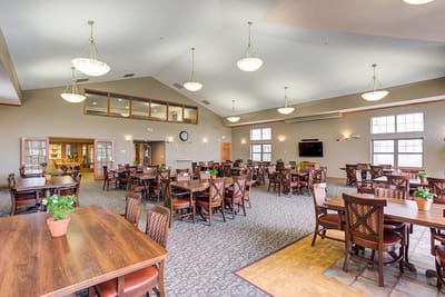 Bright and spacious dining area with wooden tables and chairs