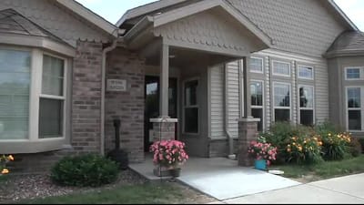 Entrance of Vista Pointe Assisted Living with flowers.