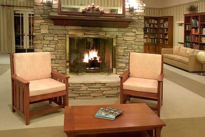 Cozy common area with stone fireplace and seating
