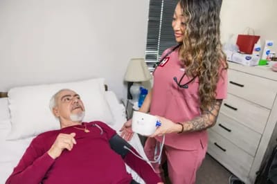 Nurse assisting a resident with health monitoring