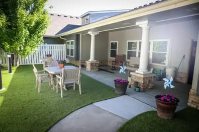 Outdoor seating area with tables and potted plants
