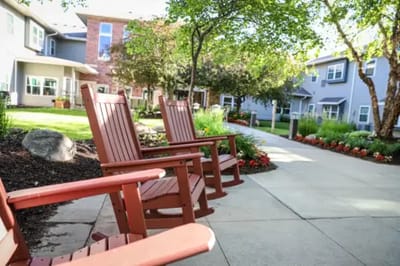 Outdoor seating area with rocking chairs and garden