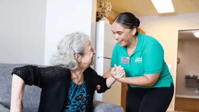 Resident interacting with staff in a warm environment