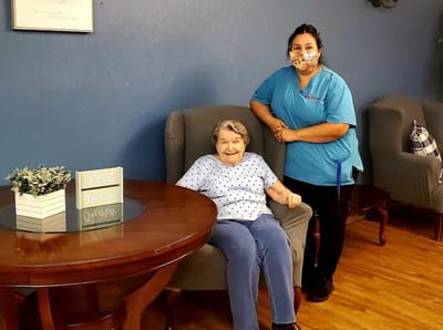 Resident and staff member in a common area