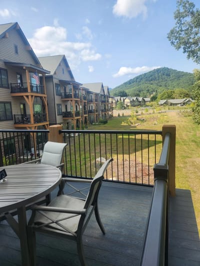 View of outdoor space with building and hills