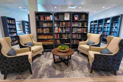 Cozy library area with comfortable seating and bookshelves