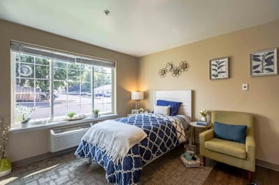 Cozy resident room with bed and seating area
