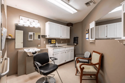 Beauty salon area with hair styling chair and sink