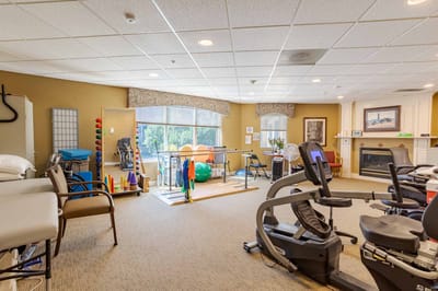 Rehabilitation gym with exercise equipment and therapy area