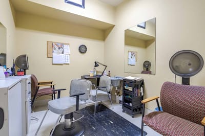 Interior view of a salon area with chairs and mirrors