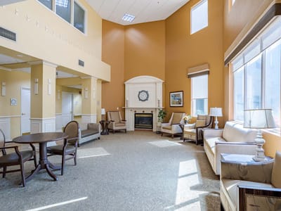 Bright and inviting common area with seating and fireplace