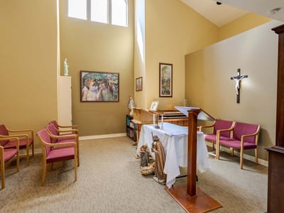 Prayer room with seating and religious decor